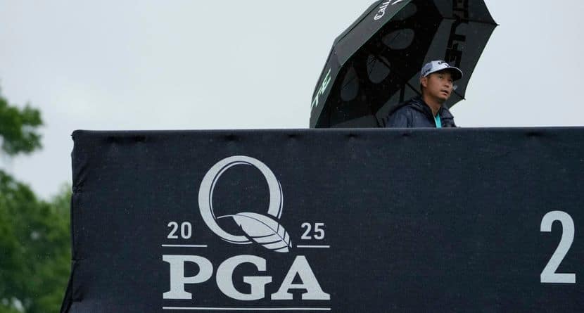 A person walks in the rain over a pedestrian bridge during a practice round for the PGA Championship golf tournament at the Quail Hollow Club, Monday, May 12, 2025, in Charlotte, N.C. (AP Photo/Matt York)
