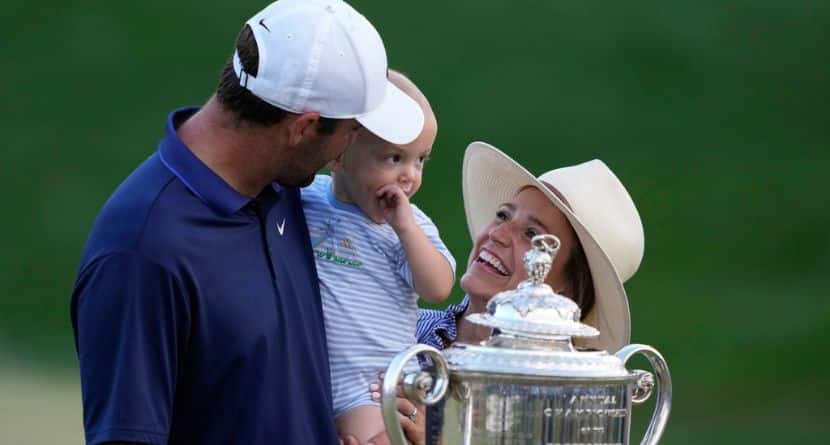 Scottie Scheffler, wife Meredith pose with their son Bennett after winning the PGA Championship golf tournament at the Quail Hollow Club, Sunday, May 18, 2025, in Charlotte, N.C. (AP Photo/Matt York)