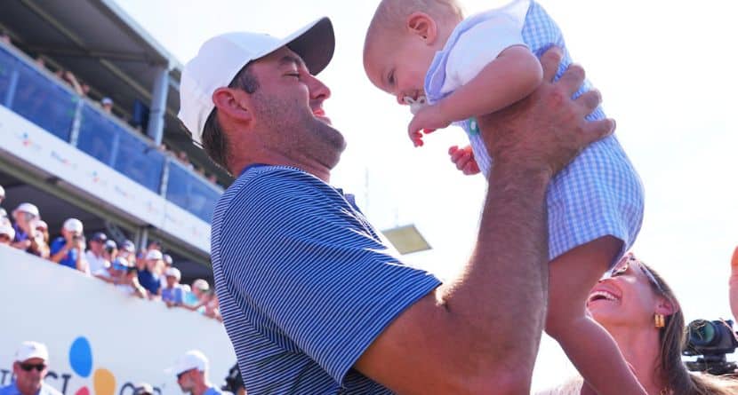 Scottie Scheffler lifts his son Bennett after winning the CJ Cup Byron Nelson golf tournament in McKinney, Texas, Sunday, May 4, 2025. (AP Photo/LM Otero)