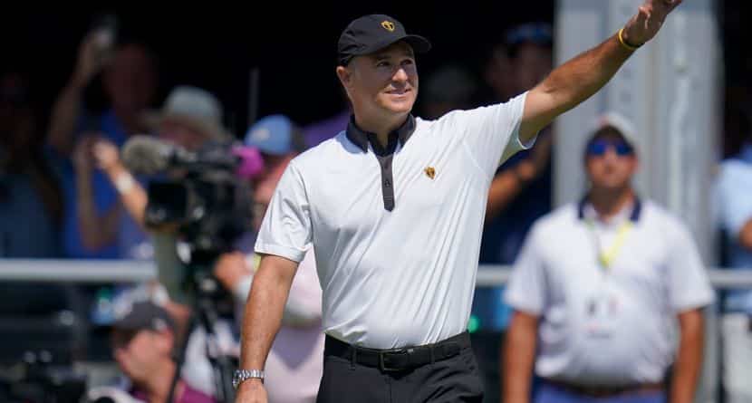 International team captain Trevor Immelman waves toward the gallery before a foursomes match at the Presidents Cup golf tournament at the Quail Hollow Club, Sept. 22, 2022, in Charlotte, N.C. (AP Photo/Julio Cortez)