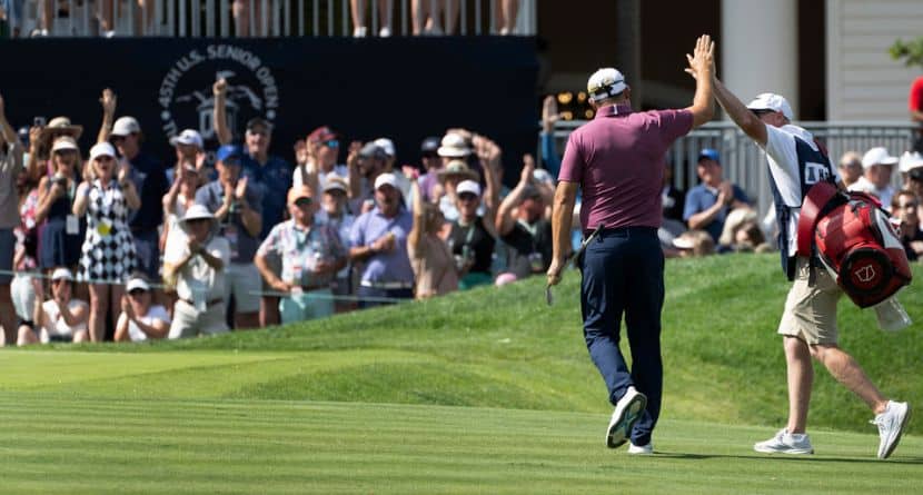 Padraig Harrington, left, high fives his caddie, Ronan Flood, after Harrington chipped in for a birdie on the 18th hole during the third round of the 45th U.S. Senior Open Championship Saturday, June 28, 2025, at the Broadmoor Golf Club in Colorado Springs, Colo. (Christian Murdock/Colorado Springs Gazette via AP)