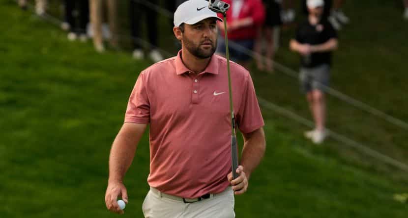 Scottie Scheffler gestures after his putt on the 18th green during the third round of the Memorial golf tournament Saturday, May 31, 2025, in Dublin, Ohio. (AP Photo/Sue Ogrocki)