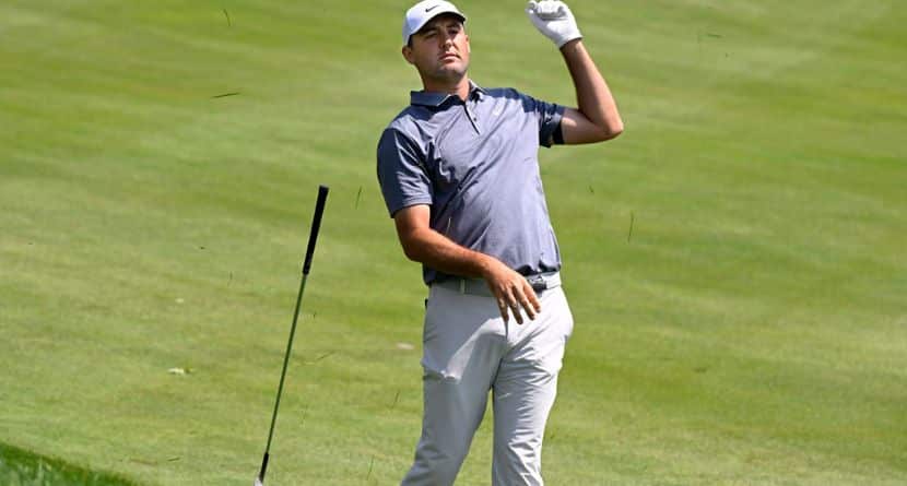 Scottie Scheffler drops his club after hitting his second shot from the rough on the first hole during the second round of the Travelers Championship golf tournament at TPC River Highlands, Friday, June 20, 2025, in Cromwell, Conn. (AP Photo/Jessica Hill)