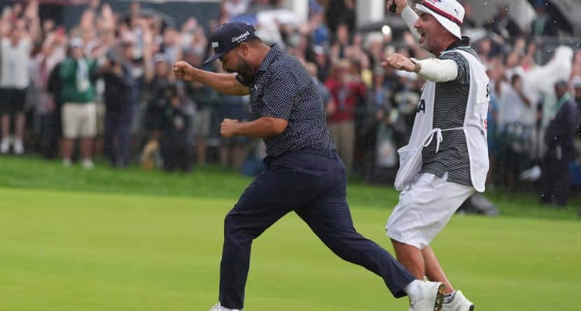 J.J. Spaun celebrates with his caddie, Mark Carens, after making a birdie putt on the 18th hole during the final round of the U.S. Open golf tournament at Oakmont Country Club Sunday, June 15, 2025, in Oakmont, Pa. (AP Photo/Seth Wenig)