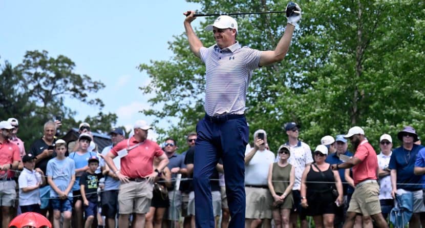 Jordan Spieth stretches at the first hole during the first round of the Travelers Championship golf tournament at TPC River Highlands, Thursday, June 19, 2025, in Cromwell, Conn. (AP Photo/Jessica Hill)