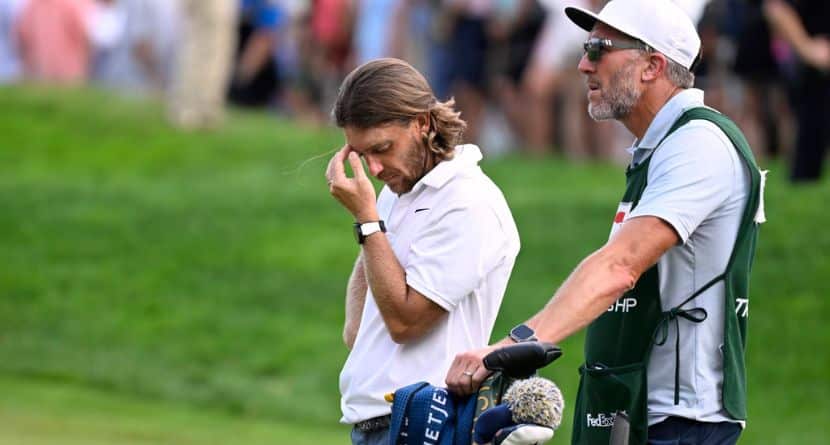 Tommy Fleetwood, from England, reacts as Keegan Bradley prepares to putt for the win during the final round of the Travelers Championship golf tournament at TPC River Highlands, Sunday, June 22, 2025, in Cromwell, Conn. At right is Fleetwood's caddie Ian Finnis. (AP Photo/Jessica Hill)