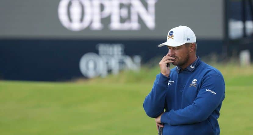 Bryson DeChambeau of the United States jokes with a member of the media staff on the 9th tee during a practice round for the British Open golf championship at the Royal Portrush Golf Club, Northern Ireland, Tuesday, July 15, 2025. (AP Photo/Jon Super)