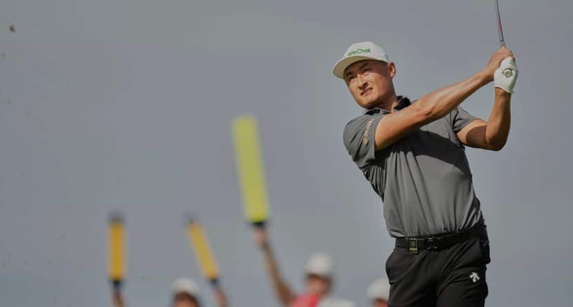 Li Haotong of China plays his shot on the 6th tee during the third round of the British Open golf championship at the Royal Portrush Golf Club, Northern Ireland, Saturday, July 19, 2025. (AP Photo/Francisco Seco)