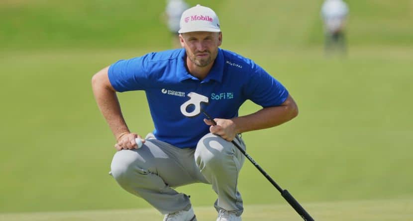 Wyndham Clark of the United States looks at the lie of his putt on the 1st green during the final round of the British Open golf championship at the Royal Portrush Golf Club, Northern Ireland, Sunday, July 20, 2025. (AP Photo/Jon Super)