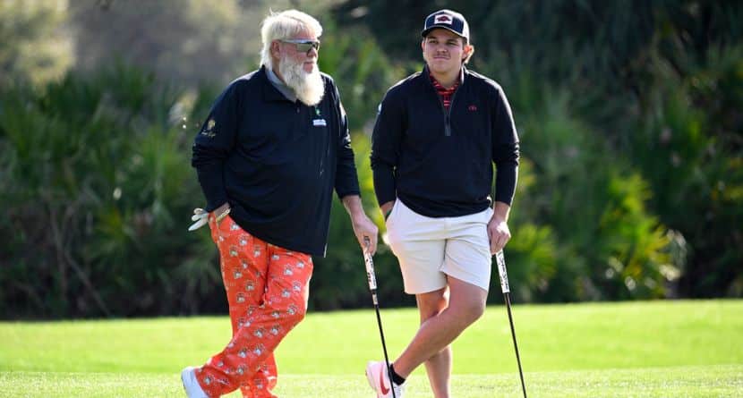 John Daly, left, and his son John Daly II wait to putt on the third green hole during the first round of the PNC Championship golf tournament, Saturday, Dec. 21, 2024, in Orlando, Fla. (AP Photo/Phelan M. Ebenhack)