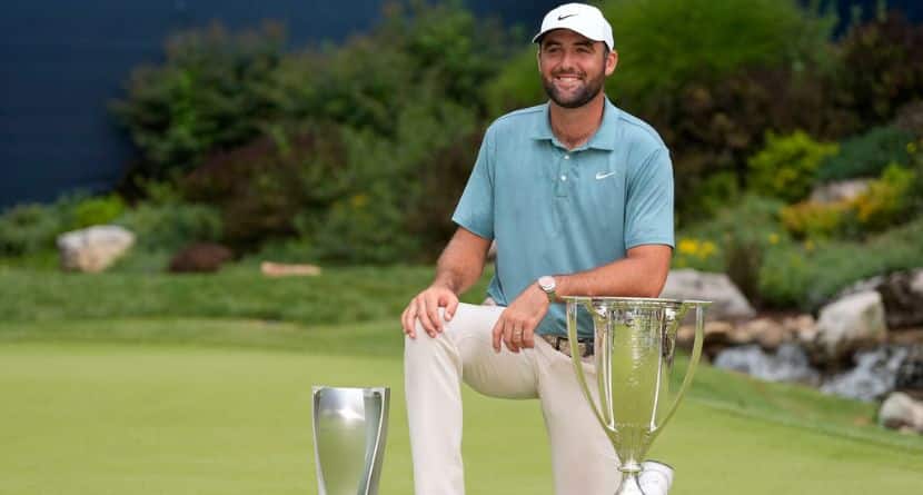 Scottie Scheffler poses with the trophies after winning the BMW Championship golf tournament Sunday, Aug. 17, 2025, in Owings Mills, Md. (AP Photo/Stephanie Scarbrough)