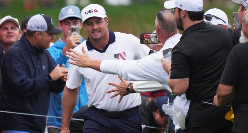 Fans greets United States' Bryson DeChambeau on the 17th hole during a practice round at the Ryder Cup golf tournament, Thursday, Sept. 25, 2025, on the Bethpage Black golf course, in Farmingdale, N.Y. (AP Photo/Matt Slocum)