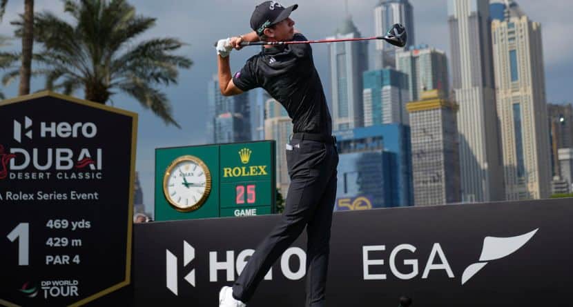Tom Mckibbin of Northern Ireland hits off the first tee during the final round of the Dubai Desert Classic golf tournament, in Dubai, United Arab Emirates, Sunday, Jan. 19, 2025. (AP Photo/Altaf Qadri)