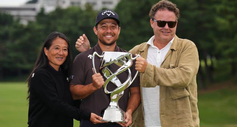 Xander Schauﬀele, of the U.S., poses for a photo with his parents, Chen Ping-Yi, left, and Stefan Schauffele, as he won the Baycurrent Classic golf tournament at the Yokohama Country Club in Yokohama, near Tokyo, Sunday, Oct. 12, 2025. (AP Photo/Hiro Komae)