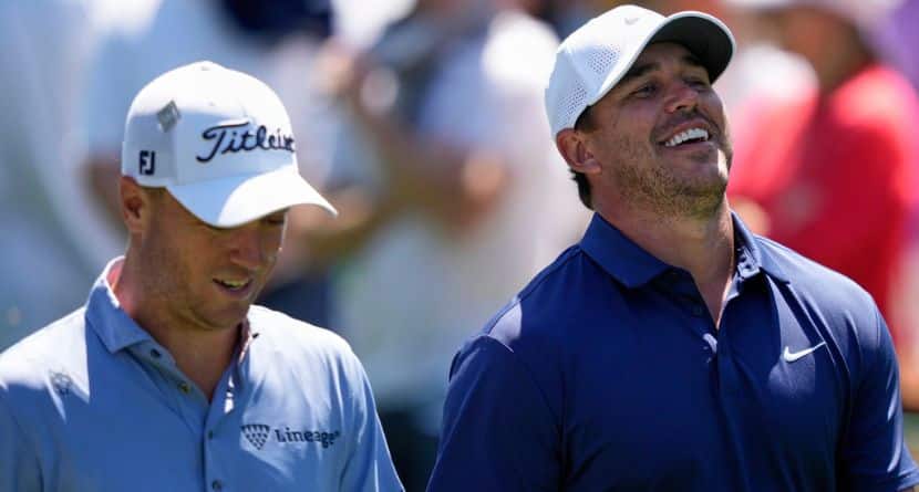 Brooks Koepka laughs while talking with Justin Thomas, left, on the 15th fairway during a practice round at the Masters golf tournament, Tuesday, April 8, 2025, in Augusta, Ga. (AP Photo/Matt Slocum)