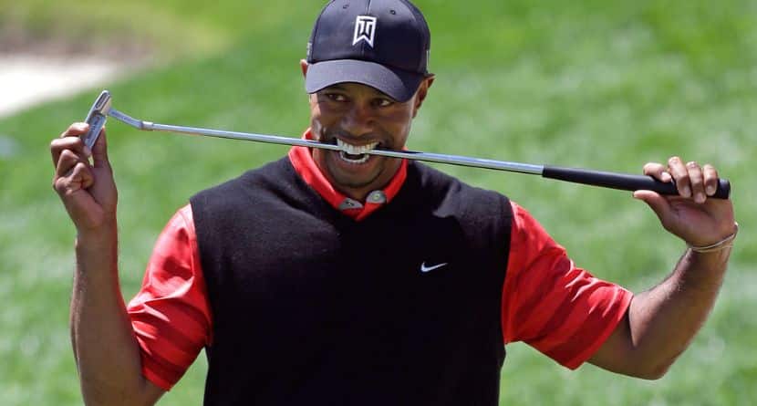 Tiger Woods bites down on his club after missing a putt for par on the 18th green during the final round of the Arnold Palmer Invitational golf tournament, March 25, 2013, in Orlando, Fla. (AP Photo/John Raoux)