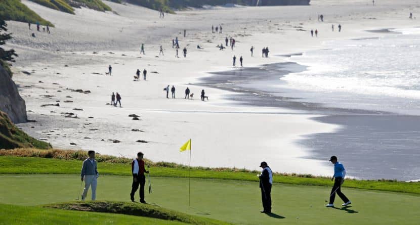 In this Feb. 6, 2013, file photo, Roberto Castro, right, walks to his ball on the tenth green of the Pebble Beach Golf Links during a practice round of the AT&T Pebble Beach Pro-Am golf tournament in Pebble Beach, Calif. It's played on one of the world's most picturesque courses on the first weekend after the Super Bowl, offering magnificent views of the Monterey Peninsula to golf fans still digging out from the snow. (AP Photo/Eric Risberg)