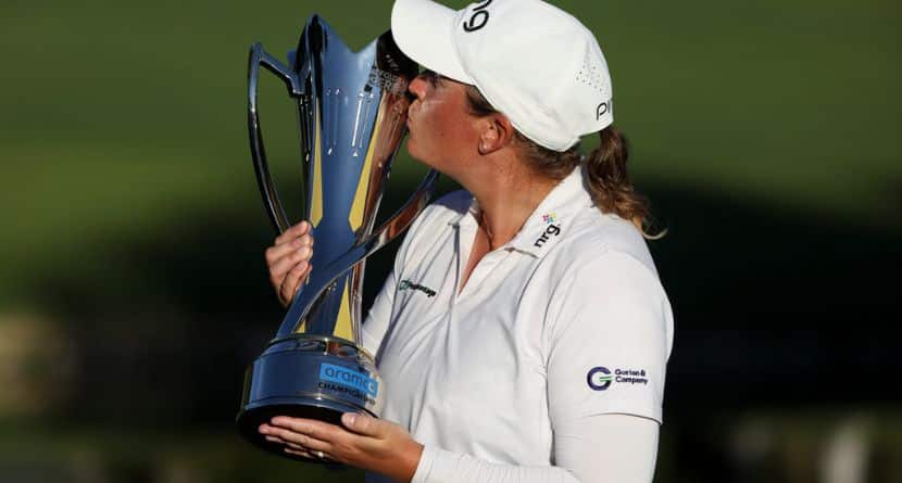 Lauren Coughlin kisses the trophy after winning the Aramco Championship golf tournament Sunday, April 5, 2026, in North Las Vegas, Nev. (AP Photo/Ian Maule)
