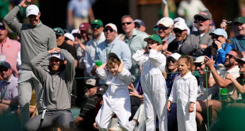 Rory McIlroy, from left, and Tommy Fleetwood react to a shot with his son, Franklin, Shane Lowry's daughter, Iris, and Rory McIlroy's daughter, Poppy, on the seventh hole during par-3 contest ahead of the Masters golf tournament at the Augusta National Golf Club, Wednesday, April 8, 2026, in Augusta, Ga. (AP Photo/Eric Gay)