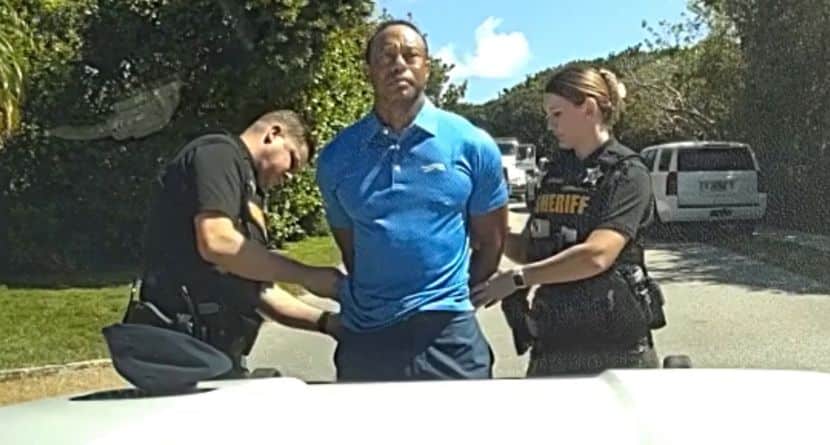 In this image from police body camera video released by the Martin County, Fla., Sheriff's Office, golfer Tiger Woods is taken into custody by sheriff's deputies following a car crash in Jupiter Island, Fla., Friday, March 27, 2026. (Martin County Sheriff's Office via AP)