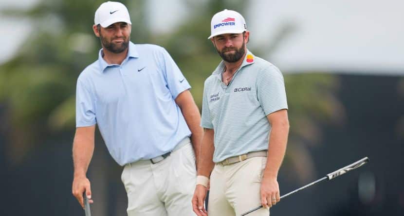 Scottie Scheffler, left, leans to watch Cameron Young's putt on the ninth green during the final round of the Cadillac Championship PGA golf tournament Sunday, May 3, 2026, in Doral, Fla. (AP Photo/David J. Phillip)