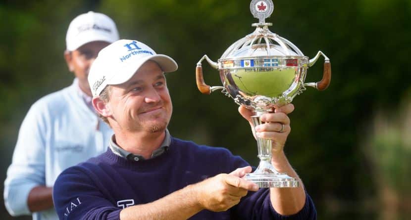 Bud Cauley, of the United States, holds the trophy after winning the Canadian Open golf tournament in Caledon, Ontario, Sunday June 14, 2026. (Frank Gunn/The Canadian Press via AP)
