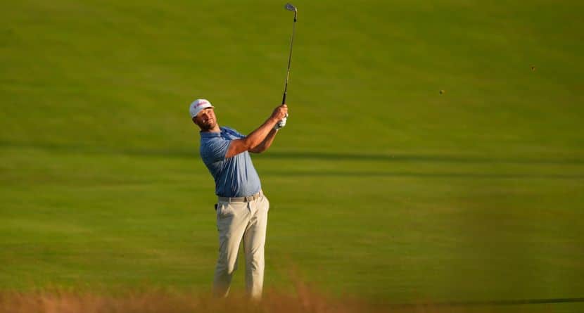 Wyndham Clark hits from the fairway on the third hole during the first round of the U.S. Open golf tournament at Shinnecock Hills Golf Club in Southampton, N.Y., Thursday, June 18, 2026.(AP Photo/David J. Phillip)