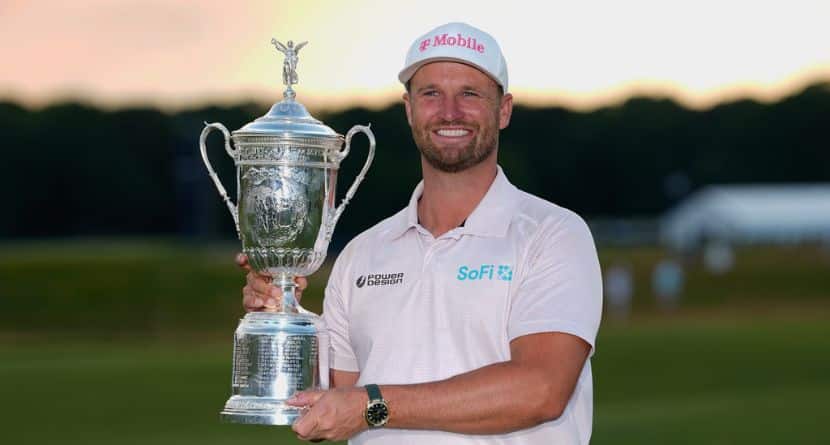 Wyndham Clark holds the trophy after winning the U.S. Open golf tournament at Shinnecock Hills Golf Club in Southampton, N.Y., Sunday, June 21, 2026. (AP Photo/Gerald Herbert)
