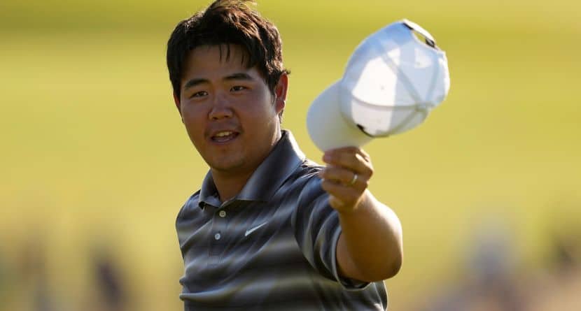 Tom Kim, of South Korea, waves after his putt on the 18th hole during the final round of the U.S. Open golf tournament at Shinnecock Hills Golf Club in Southampton, N.Y., Sunday, June 21, 2026. (AP Photo/George Walker IV)