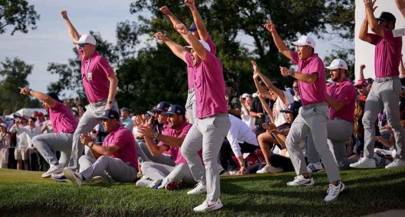 Members of the USA team celebrate Jackson Koivun's win on the 18th green against the International team during a Presidents Cup golf tournament final round singles match at Medinah Country Club, Sunday, Sept. 27, 2026, in Medinah, Ill. (AP Photo/Matt Slocum)