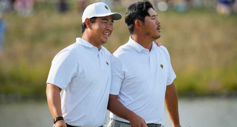 International teams' Tom Kim, of South Korea, laughs after Si Woo Kim, of South Korea, right, missed a putt on the 13th green against the USA team during a Presidents Cup golf tournament third round foursome match at Medinah Country Club, Saturday, Sept. 26, 2026, in Medinah, Ill. (AP Photo/Chris Carlson)