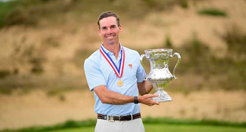 In this photo provided by USGA , Andrew Bailey holds the Robert T. Jones Jr. Memorial Trophy after winning the championship at the 2026 U.S. Mid-Amateur at Sand Valley Resort (The Lido) in Nekoosa, Wis. on Thursday, Oct. 1, 2026. (Logan Whitton/USGA via AP).